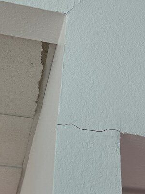 Close-up detail of drywall corner crack before repair